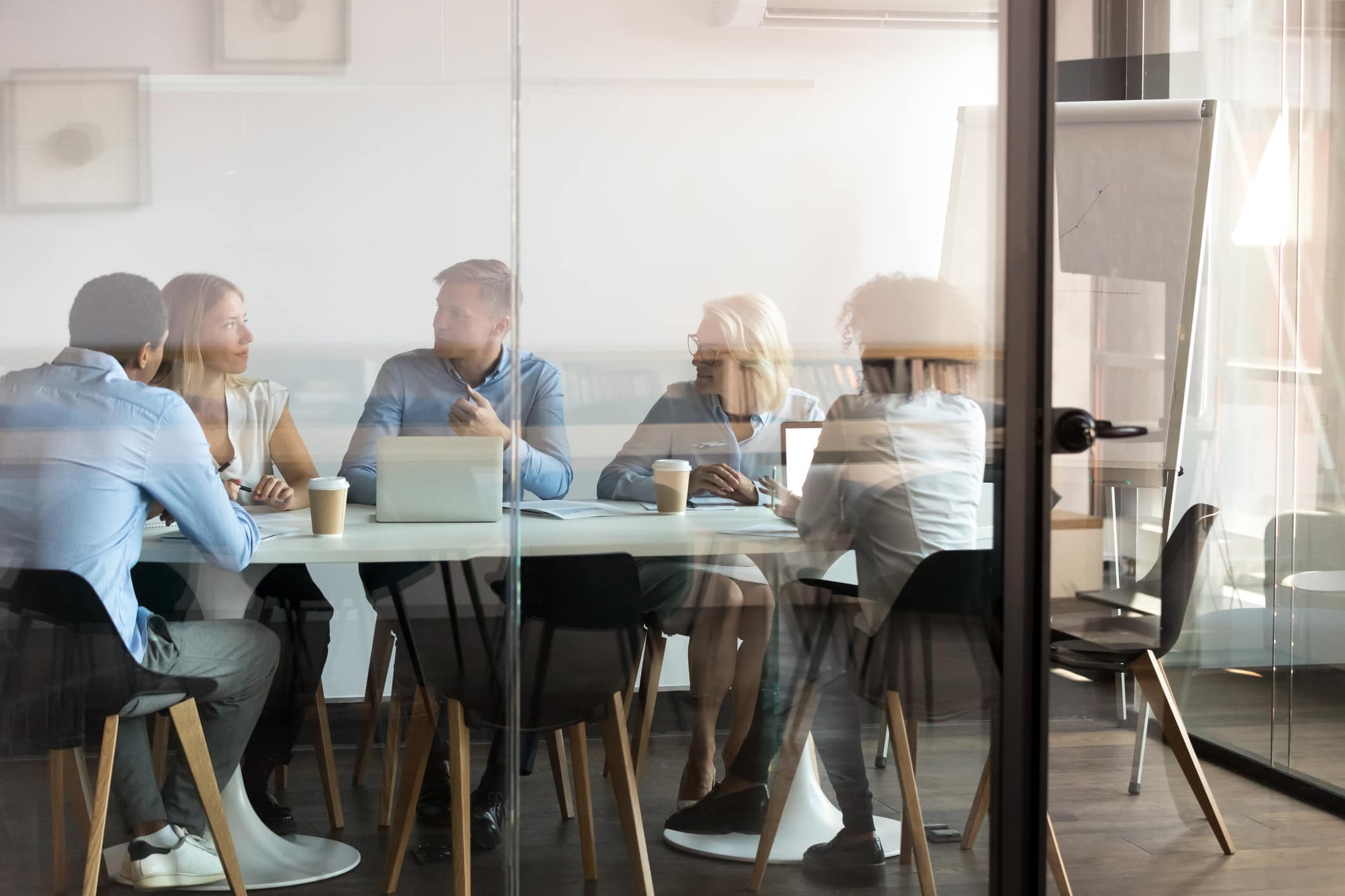 Business people negotiating at boardroom behind closed doors 7T Development Process - Discover